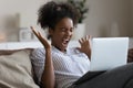 Overjoyed young african american woman celebrating online win.