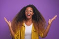 Overjoyed young African American woman screams excitedly and waves hands Royalty Free Stock Photo