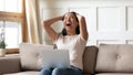 Overjoyed young asian ethnic woman reading email with unbelievable news. Royalty Free Stock Photo