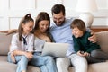 Happy family with kids relax on couch using laptop Royalty Free Stock Photo