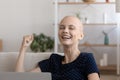 Excited hairless cancer patient read good results on gadget