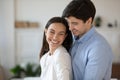 Overjoyed young couple hug showing care and affection