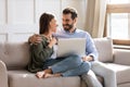 Happy couple relax on sofa using laptop Royalty Free Stock Photo