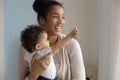 Overjoyed young ethnic mom cuddle little baby daughter Royalty Free Stock Photo