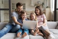 Overjoyed young family with kids using laptop together Royalty Free Stock Photo