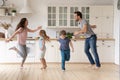 Overjoyed young family dancing with little kids at home Royalty Free Stock Photo