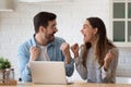 Overjoyed young family spouse celebrating online lottery win.