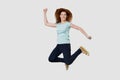 Overjoyed young happy red-haired woman jumping high. Royalty Free Stock Photo