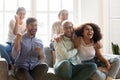 Overjoyed young mixed race people supporting favorite team. Royalty Free Stock Photo