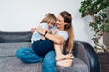 Overjoyed young mother having fun with her kid at home, laughing happy mum, adorable son playing funny active game Royalty Free Stock Photo