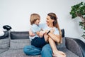 Overjoyed young mother having fun with her kid at home, laughing happy mum, adorable son playing funny active game Royalty Free Stock Photo