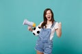 Overjoyed young woman football fan support favorite team with soccer ball megaphone doing winner gesture isolated on Royalty Free Stock Photo