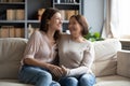 Overjoyed young woman with mature mother chatting, laughing, having fun Royalty Free Stock Photo