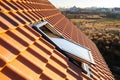 Overlapping rows of yellow ceramic roofing tiles covering residential building roof Royalty Free Stock Photo