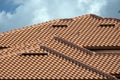 Overlapping rows of yellow ceramic roofing tiles covering residential building roof in southern Florida Royalty Free Stock Photo