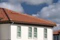 Overlapping rows of yellow ceramic roofing tiles covering residential building roof in southern Florida Royalty Free Stock Photo