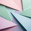 Overlapping sheets of pastel-colored paper create a geometric pattern. Triangular Royalty Free Stock Photo
