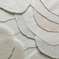 Overlapping sheets of textured, circular paper in shades of white and beige are Royalty Free Stock Photo