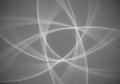 Overlapping white wave-like patterns create a complex, symmetrical design on a grey Royalty Free Stock Photo
