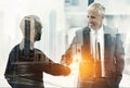 Overlay, partnership and business men shaking hands in agreement in the city for corporate success. Double exposure Royalty Free Stock Photo