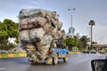 Overloaded with bags of waste, vehicle moves on higway, Iran