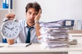 The overloaded busy employee with too much work and paperwork