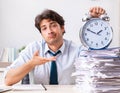 Overloaded busy employee with too much work and paperwork