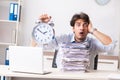 The overloaded busy employee with too much work and paperwork Royalty Free Stock Photo