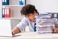 The overloaded busy employee with too much work and paperwork Royalty Free Stock Photo