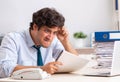 Overloaded busy employee with too much work and paperwork