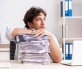 Overloaded busy employee with too much work and paperwork