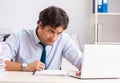 Overloaded busy employee with too much work and paperwork Royalty Free Stock Photo