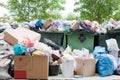 Overloaded dumpster, full garbage container, household garbage bin, trash can, heap of unsorted rubbish, pile of refuse, litter Royalty Free Stock Photo