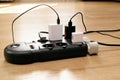 Overloaded power adaptor multiple socket. Surge Protector Power Strip, Phone Charger Cable. Plugs in Outlet Royalty Free Stock Photo