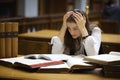 Overloaded student in library Royalty Free Stock Photo