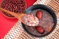 Overlooking a bowl of eight treasures porridge, porridge with wooden spoon and a plate of red beans