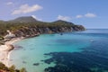 Overlooking Cala d Hort beach in Ibiza, this image captures pristine emerald waters, sandy shoreline, anchored boats