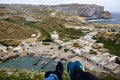 Overlooking inland sea with little houses next to it and fungus rock in the background in gozo, Malta.