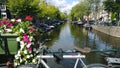 Overlooking one of the canals of Amsterdam in the Netherlands. The seat and the handlebars of the bike in the frame