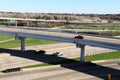 Overlooking a very busy interstate highway off ramp from above with multiple lanes of freeway traffic below