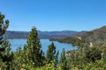 Overlooking Wiskey Lake in Northern California surrounded by pine trees with a twisting road headed west through the mountians Royalty Free Stock Photo