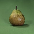 Overly Ripe Comice Pear Isolated on Green Fabric