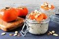 Overnight breakfast oatmeal with persimmons, table scene