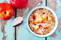 Overnight breakfast oats with peach and coconut on rustic wood