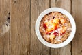 Overnight breakfast oats with peach and coconut on rustic wood