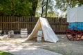 Overnight canvas tent beside a blue Prairie Schooner wagon