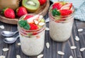 Overnight oatmeal with fresh strawberry and kiwi, garnished with sliced almond in glass jar Royalty Free Stock Photo