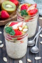 Overnight oatmeal with fresh strawberry and kiwi in glass jar Royalty Free Stock Photo