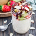 Overnight oatmeal with fresh strawberry and kiwi in glass jar, square format Royalty Free Stock Photo