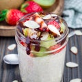 Overnight oatmeal with fresh strawberry and kiwi in glass jar, square Royalty Free Stock Photo